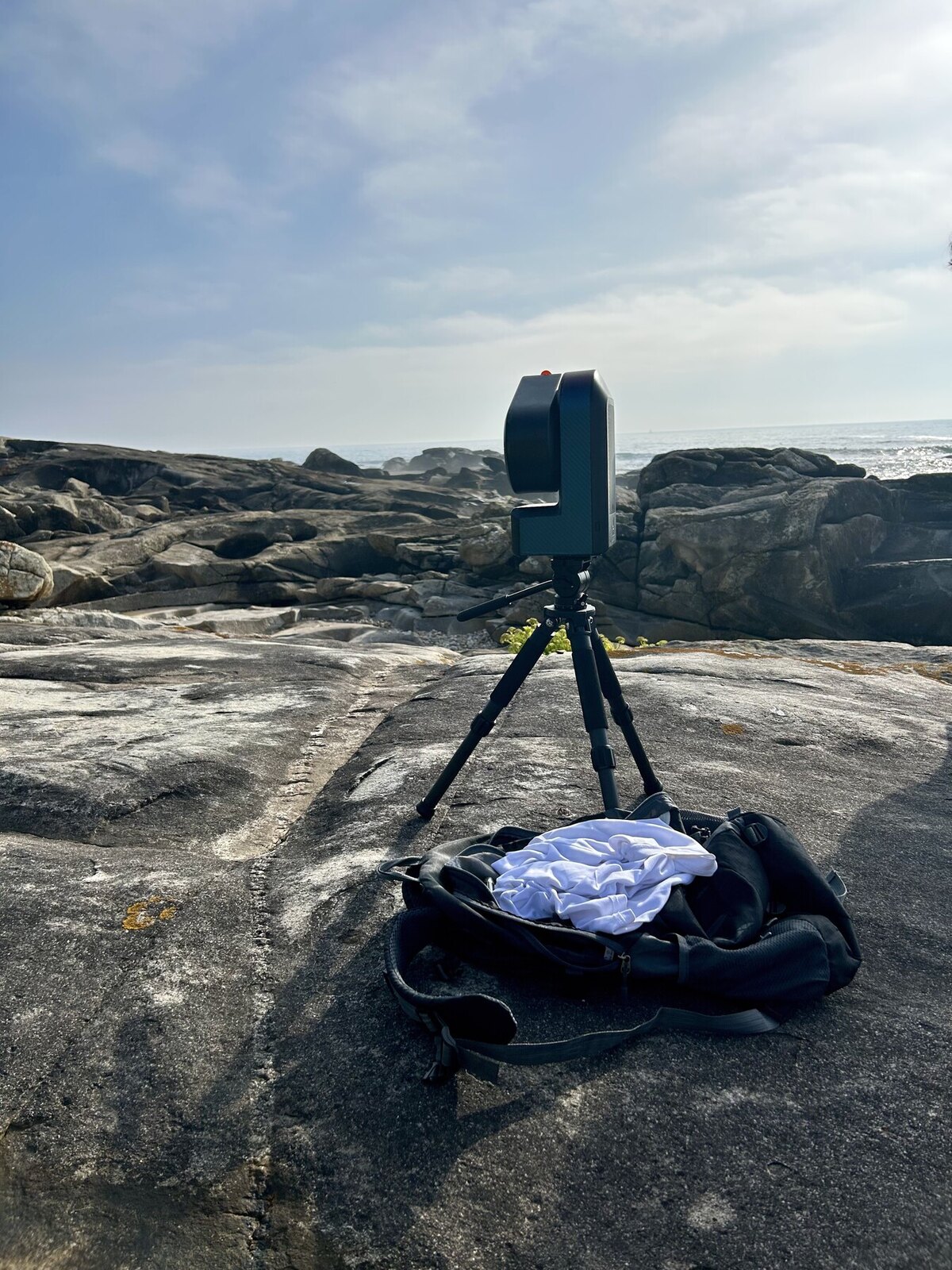 Seestar telescope on a tripod at the rocky coastal observing locality before the eclipse recording